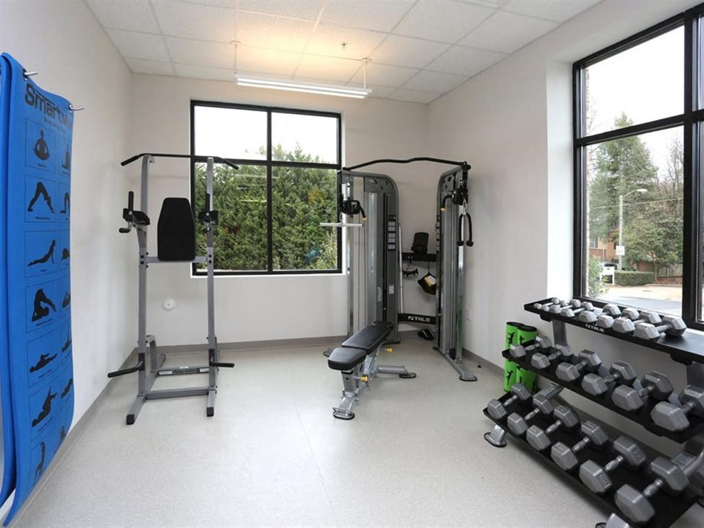 the gym in the new building has plenty of equipment and windows