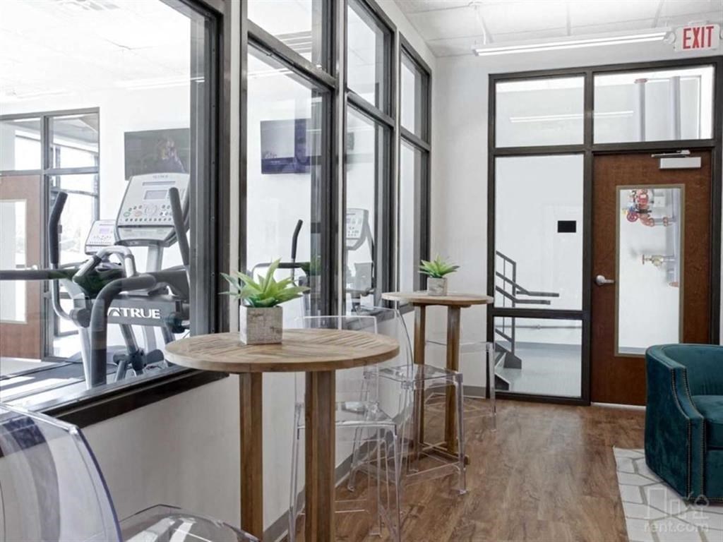 a seating area with tables and chairs in a lobby