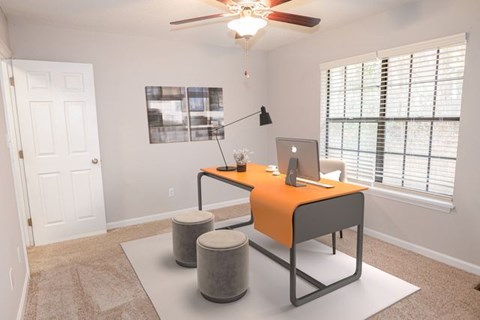 A room with a desk and a chair.