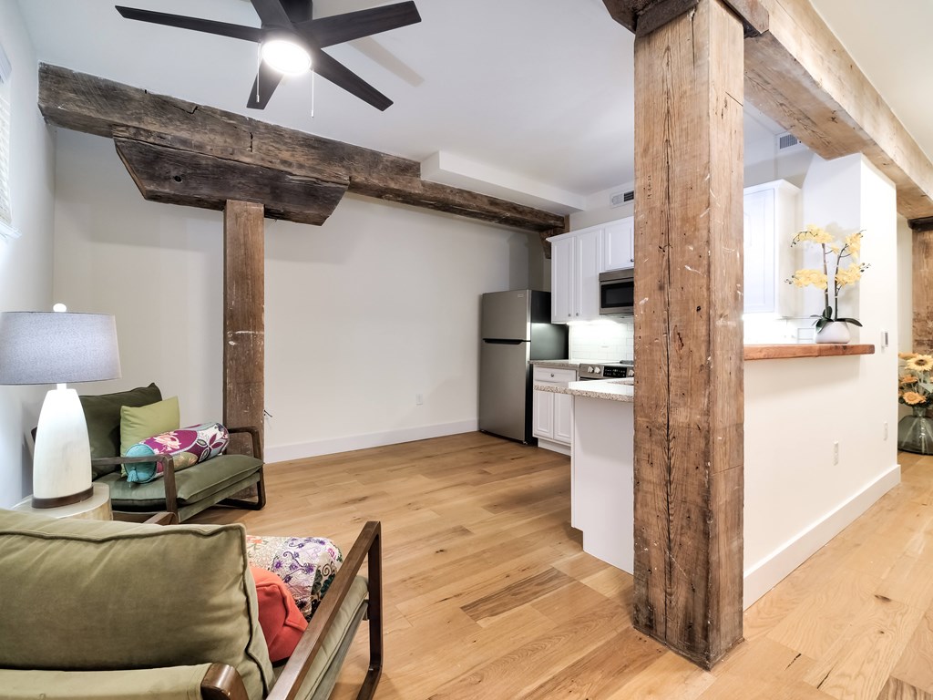 A living room with a couch and a ceiling fan.