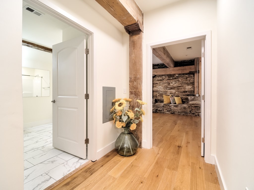 A room with a wooden floor and a white door.