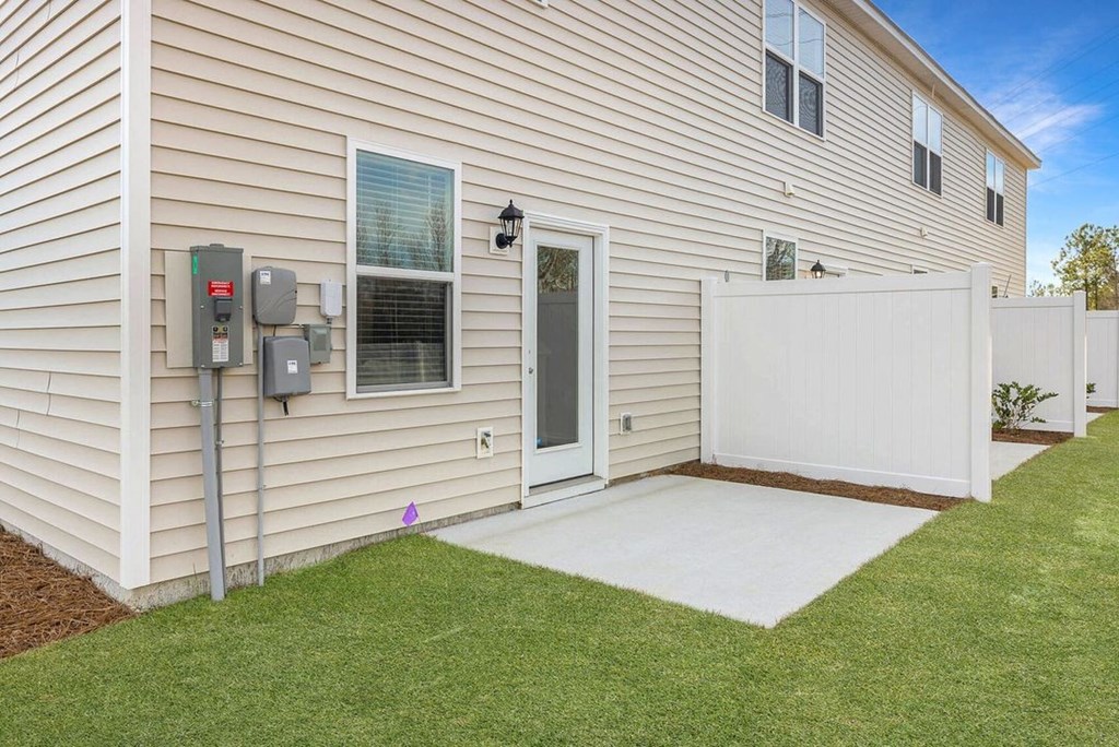 A house with a white garage door and a brown wall.