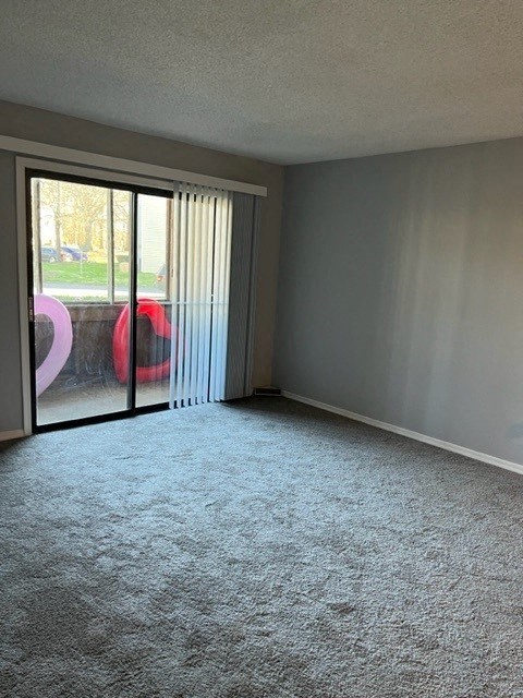 an empty living room with a sliding glass door