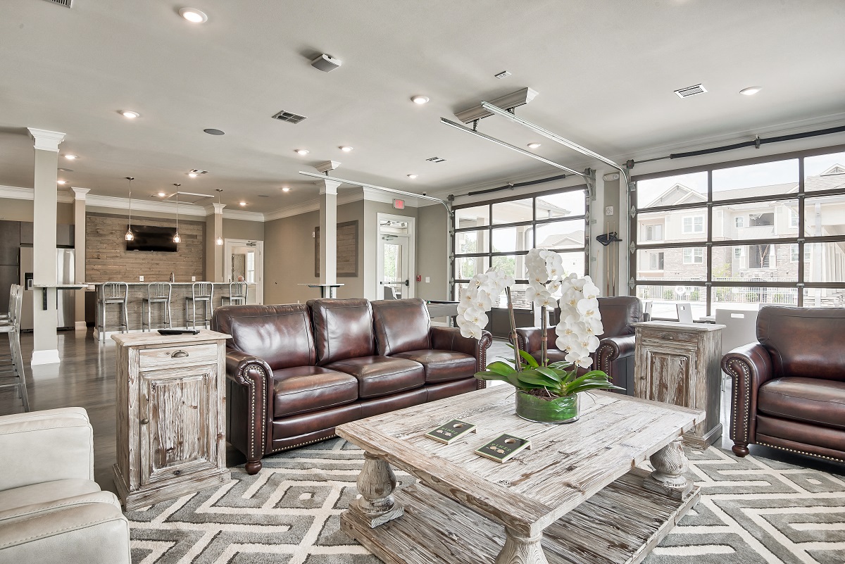 a large living room with leather furniture and a coffee table