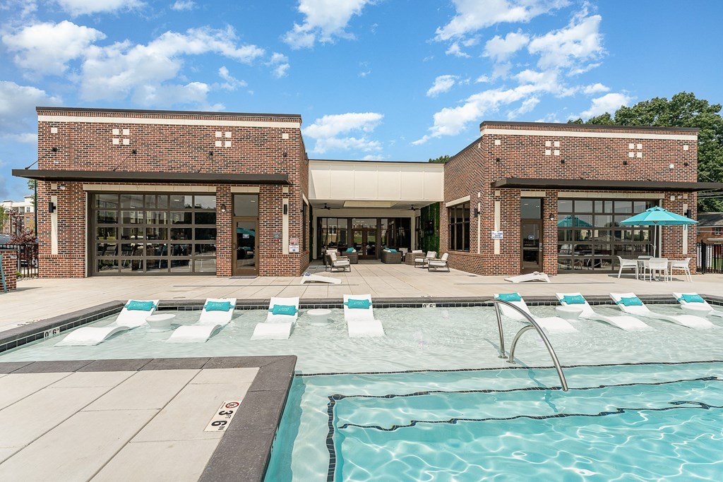 a brick building with a pool in front of it