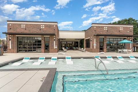 a brick building with a pool in front of it