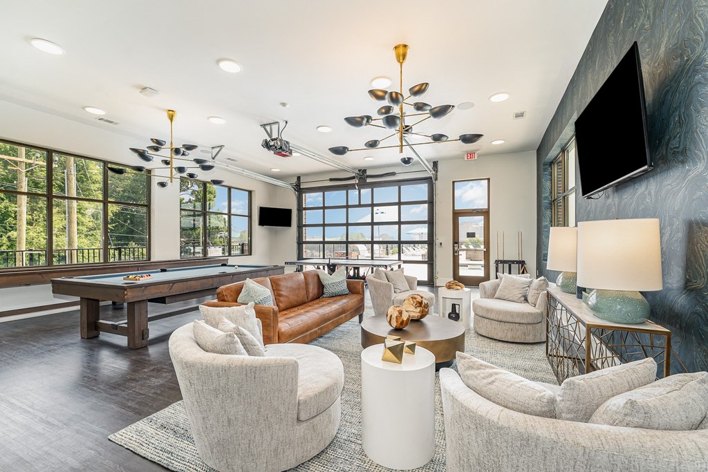 a living room filled with furniture and a pool table