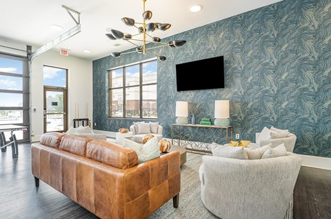 a living room with blue wallpaper and a large window