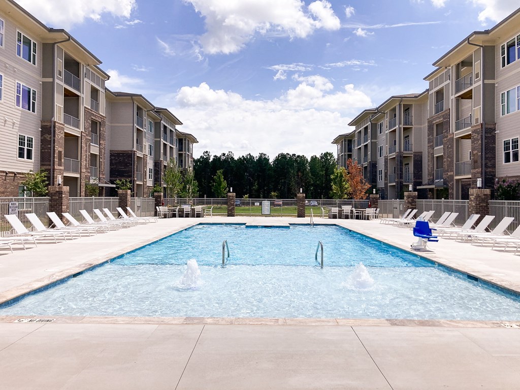a swimming pool in front of an apartment building