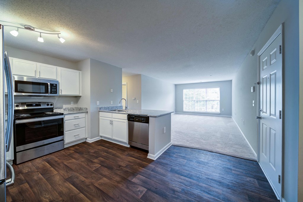 Unfurnished View of Open Floor Plan Living Area with Kitchen, Dining Area, and Living Room