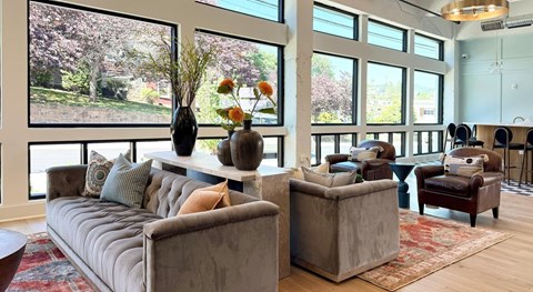 A living room with a grey couch and a brown armchair.