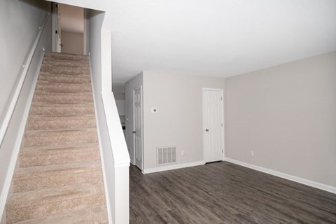 A room with a staircase leading to the upper floor.