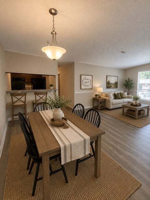 A dining room with a wooden table and chairs.