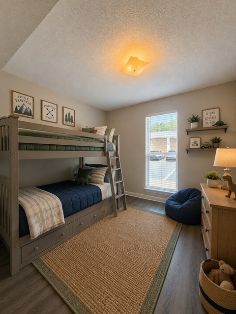 A bedroom with a bunk bed and a window.
