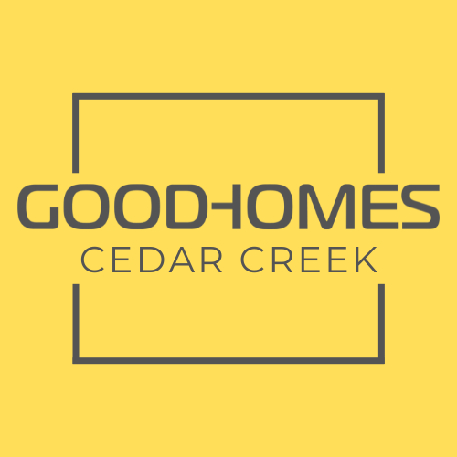 A yellow sign with the words Good-Homes Cedar Creek.
