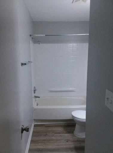 a bathroom with a toilet and a bath tub