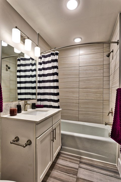 A bathroom with a white sink and a white bathtub.