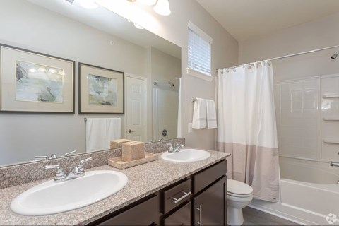 A bathroom with a white sink, toilet, and bathtub.
