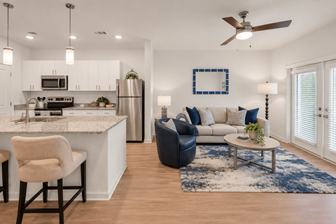 A modern kitchen with a dining area and a living room.