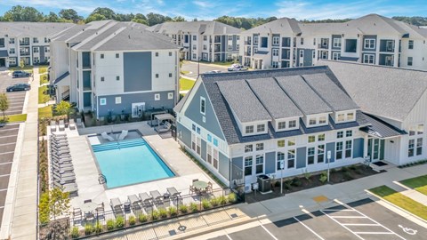 A large building with a pool in front of it.