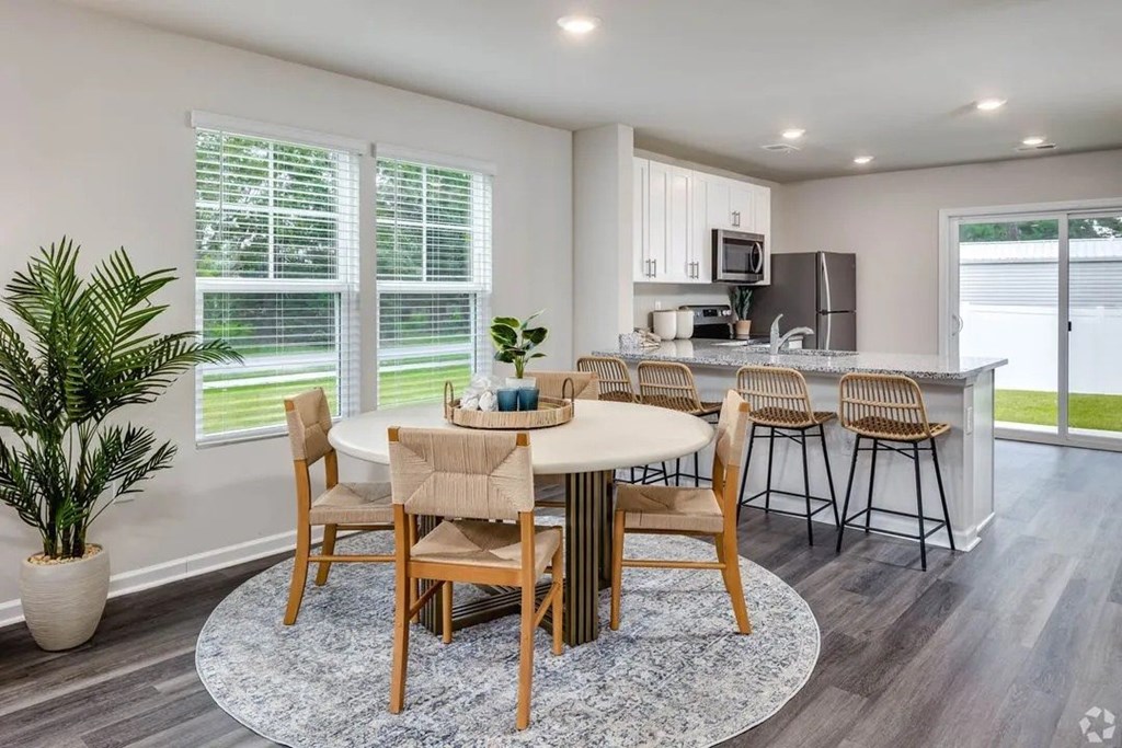 A dining room with a table set for six.