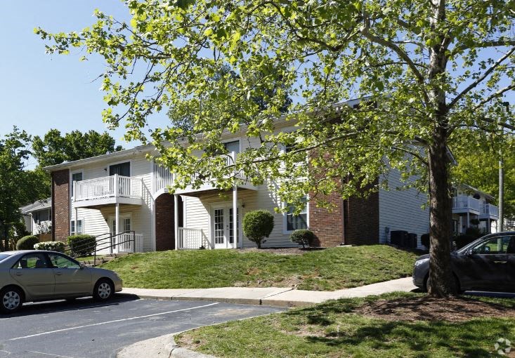 a white house with a car parked in front of it
