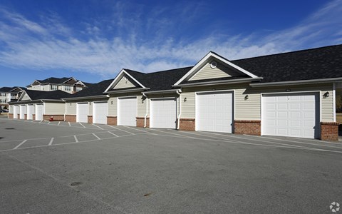 A row of garages with a clear blue sky above.