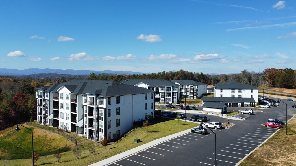 A large white building with a parking lot in front of it.
