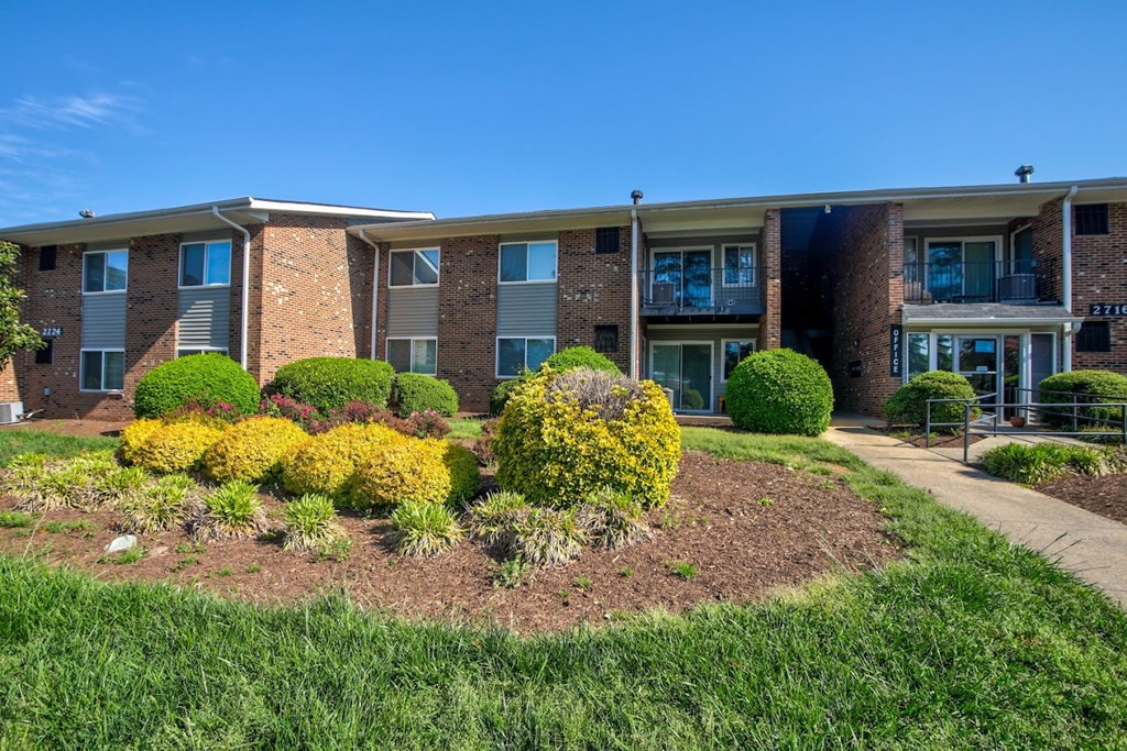 A building with a garden in front of it.