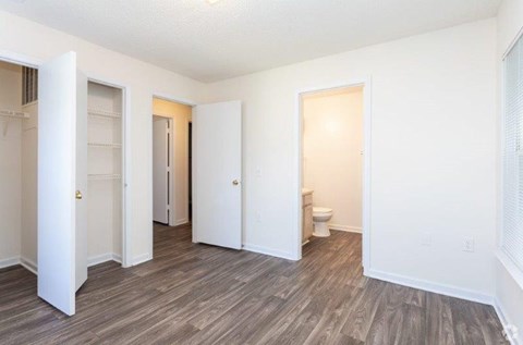 A room with a toilet and a door on the right.