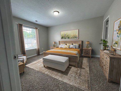 A bedroom with a bed, dresser, and window.