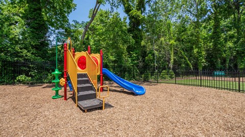 Community playground with a colorful play structure and slides at Jefferson Flats.