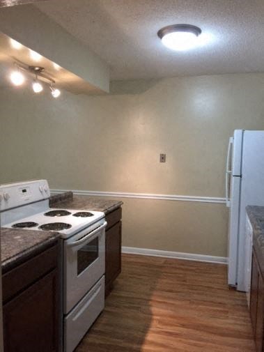 a kitchen with a stove and a refrigerator