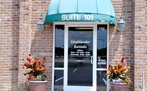 A building with a green awning and a sign that says "SUITE 101".
