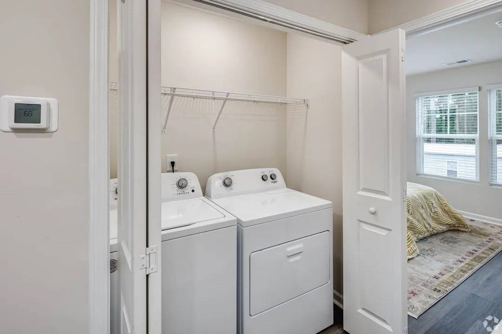 A small laundry room with a washer and dryer.