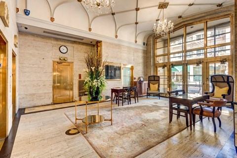 A large room with a wooden floor and a chandelier hanging from the ceiling.