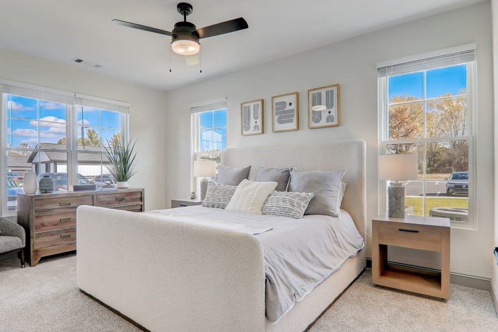 Dog-Friendly Garden-Style Apartments In Weaverville, NC - Highline North - Spacious Bedroom With Plush Carpeting, Ceiling Fan, And Multiple Windows For Natural Light