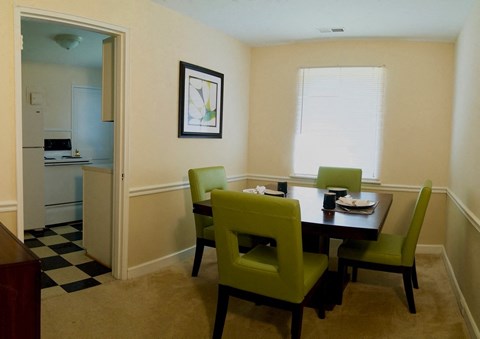 a dining room with a table and chairs and a kitchen