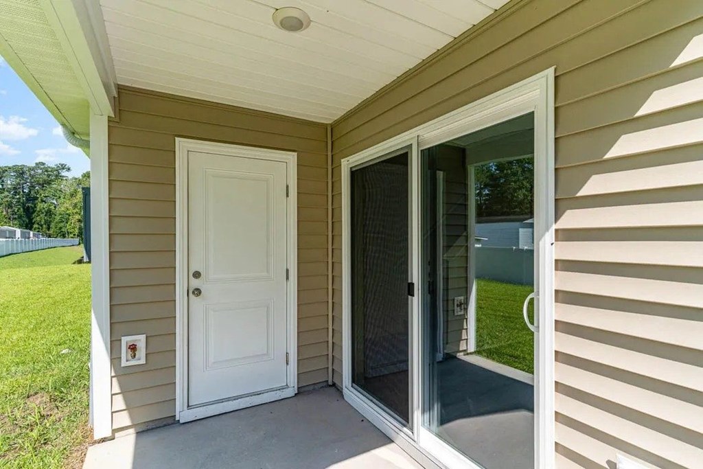 A white door is on the left and a sliding glass door is on the right.