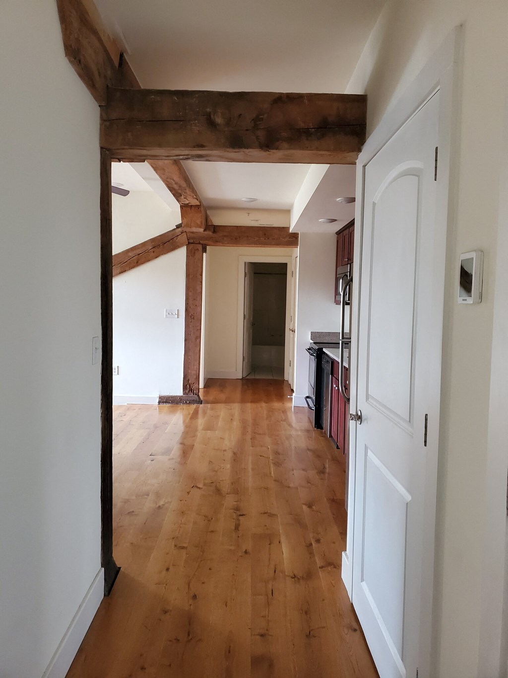 a view from the living room into the kitchen and dining room