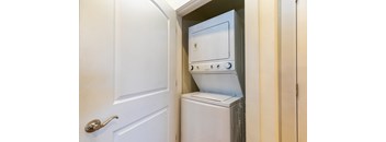 the laundry room has a washer and dryer and a door to the closet