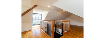 a baby crib in the middle of a room with wood floors and a window