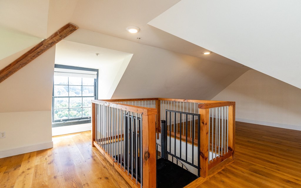 a baby crib in the middle of a room with wood floors and a window