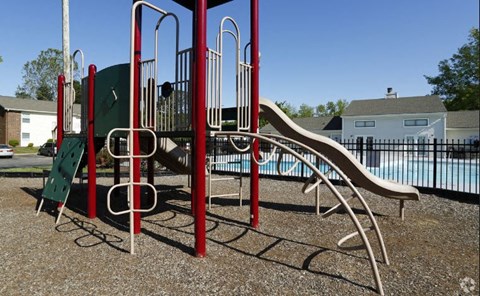 a playground with a slide and climbing equipment