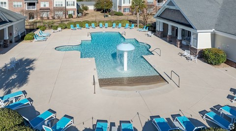 An aerial view of a swimming pool surrounded by lounge chairs.