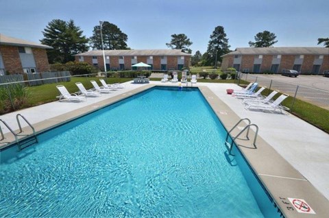 A large swimming pool with a no-diving sign.