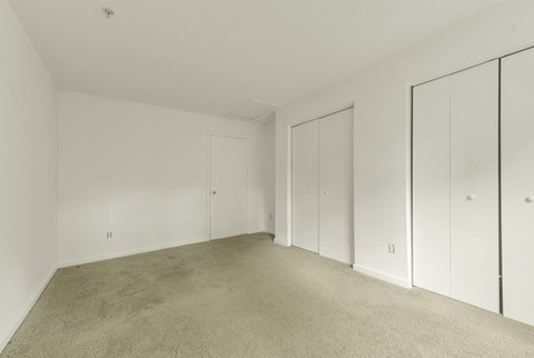 A room with white walls and a carpeted floor.
