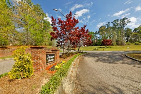 A red tree stands next to a sign that says "Welcome to Hillcrest".