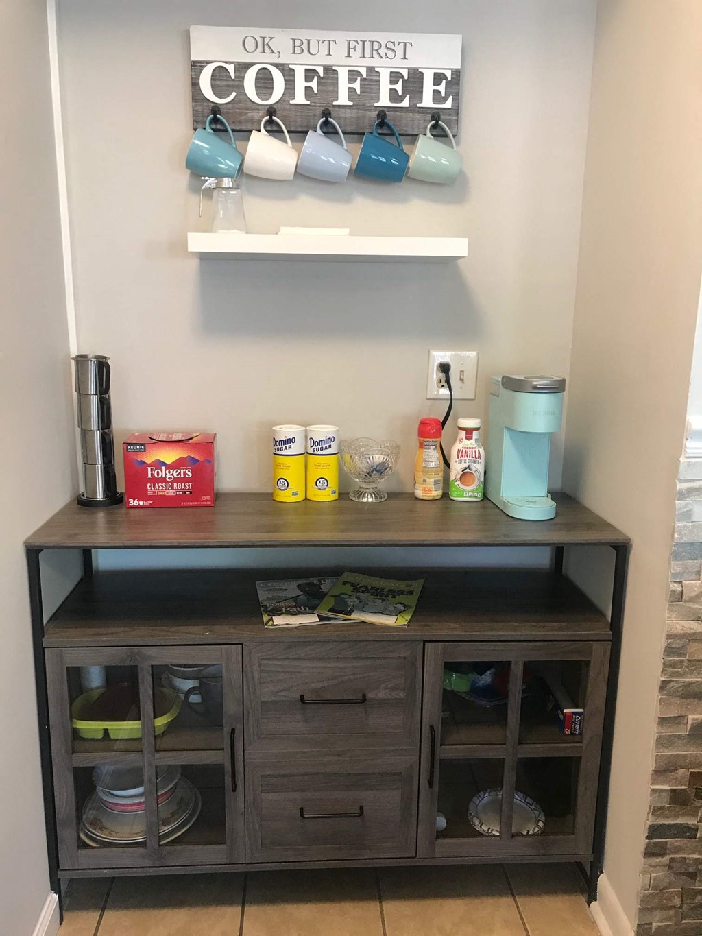 a coffee bar with a shelf and coffee cups on the wall