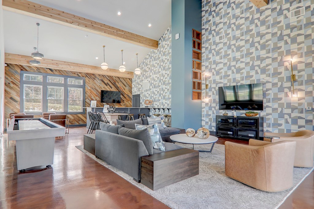 A modern living room with a grey sofa and a wooden coffee table.